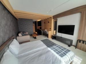 a hotel room with a bed and a television at Woodside RENT Kopaonik in Kopaonik