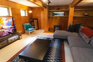 a living room with a couch and a tv at VILLA SHINANO in Shinano