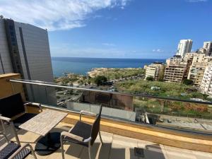 a balcony with chairs and a view of the ocean at Lancaster Suites Raouche in Beirut