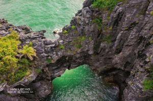 an aerial view of a rock cliff next to the ocean at Pink Boutique Inn - Hotel Elite in Cat Ba