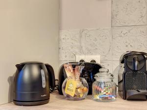 a kitchen counter with a coffee maker and a toaster at La Romantique des Rois # Jacuzzi # Sauna in Dourdan