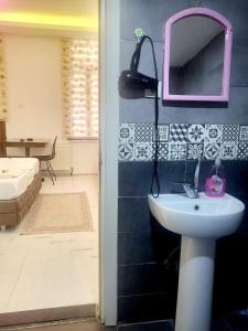 a bathroom with a sink and a mirror and a tub at taksim 34 apart istanbul in Istanbul