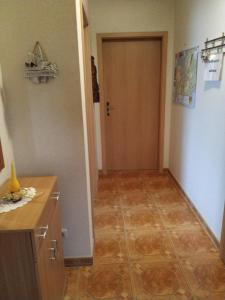 a hallway with a door and a tile floor at Ferienwohnung Kijas in Wismar