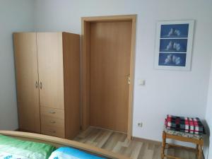 a bedroom with a closet and a wooden door at Ferienwohnung Kijas in Wismar