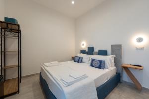 a bedroom with a large bed with blue and white pillows at Baia Flegrea Meublè in Bacoli