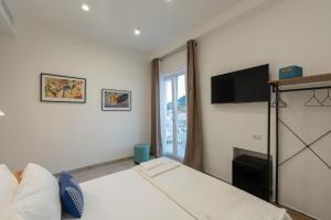 a bedroom with a bed and a large window at Baia Flegrea Meublè in Bacoli