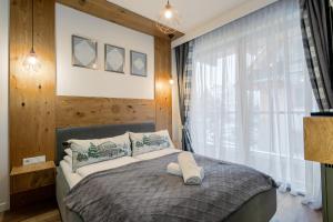 Ένα ή περισσότερα κρεβάτια σε δωμάτιο στο Apartament Góralska Nuta SPA Basen & Sauna +33 φωτογραφίες