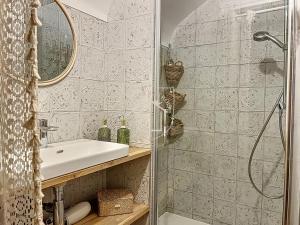 a bathroom with a sink and a shower at La Romantique des Rois # Jacuzzi # Sauna in Dourdan +16 photos