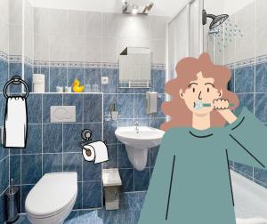 a woman brushing her teeth in a bathroom at Penzion Portus in Bratislava