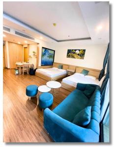 a room with a couch and a bed and a table at FLC Luxury Apartment Quy Nhon in Quy Nhon