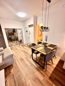 a dining room and living room with a table and chairs at Apartment Gate Old Town in Zadar