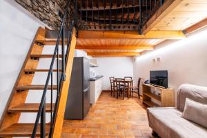 a living room with a stairs leading to a kitchen at Affittacamere La Rocca Campiglia in Campiglia Marittima