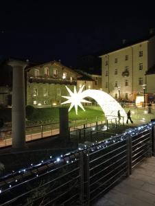 a light sculpture in front of a building at night at Maison Loren Pila in Cerise