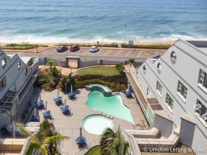 an aerial view of a resort with a pool and the ocean at Coastal Nest in Durban North