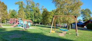un parc avec une aire de jeux et une balançoire dans l'établissement Le Village de la Champagne - Slowmoov, à Bar-sur-Aube