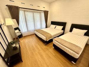 Postel nebo postele na pokoji v ubytování Villa Putih Le Cordon