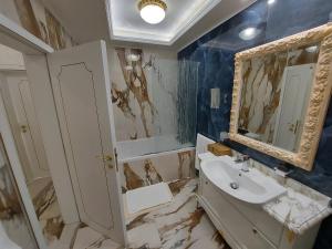 a bathroom with a sink and a mirror at Art Complex Anel in Sozopol