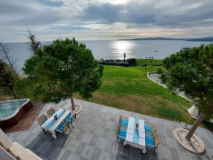 an aerial view of a table and chairs and the water at Art Complex Anel in Sozopol