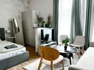a living room with a couch and a table in a room at T32 Central Modern Suites in Budapest