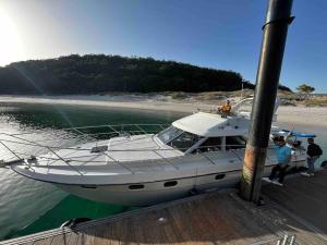 um barco está ancorado numa doca na água em El yate de la Ría em Vigo