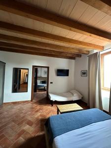 a bedroom with a bed and a couch in a room at Boma Countryhouse in Casale Bufalotta