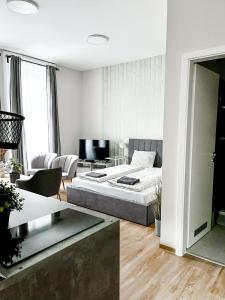 a bedroom with a bed and a living room at T32 Central Modern Suites in Budapest