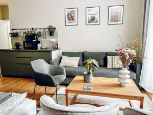 a living room with a couch and a table at T32 Central Modern Suites in Budapest +41 photos