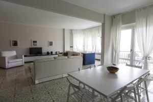 a living room with a couch and a table with chairs at Poggio Fiorito in Rapallo