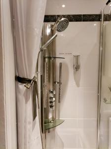 a shower in a bathroom with a shower curtain at Private Garden Room - Rural Village in Stamford