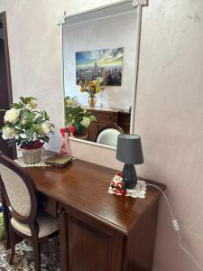 einen Schreibtisch mit Spiegel und Lampe in der Unterkunft Nel cuore di Amantea in Amantea