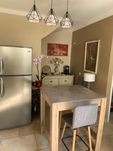 a kitchen with a table and a refrigerator at Maison proche Avignon in Barbentane
