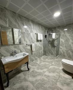a bathroom with a sink and a shower at Hisarhan Otel in Amasya