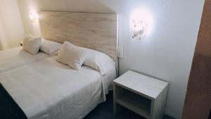 Habitación pequeña con cama y mesita de noche en Hotel Venta de la Punta, en Santa Bárbara