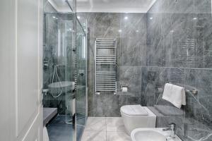 a bathroom with a toilet and a sink and a shower at Home Grifondoro Affittacamere in Genoa +49 photos