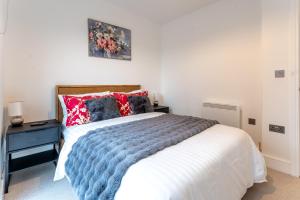 sypialnia z łóżkiem z niebiesko-białym kocem w obiekcie Prestige Apartment w Birmingham