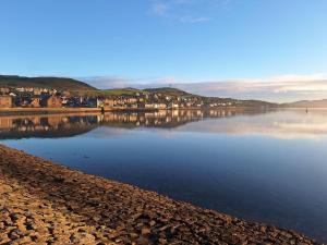 a large body of water with a town in the background at Ocean View in Campbeltown