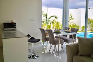 a kitchen and dining room with a table and chairs at White Villa 212 in Canggu