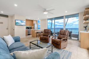 a living room with a blue couch and chairs at Nani Kai Hale A209 in Kihei
