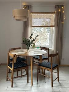 einen Tisch und Stühle in einem Zimmer mit Fenster in der Unterkunft W deSki dom apartamenty in Kreisau
