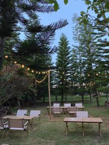 a group of tables and chairs in a park with lights at DE VARIS KHAOKHO in Ban Non Na Yao