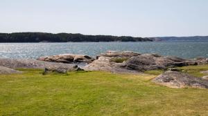 a group of rocks on the shore of a body of water at Kungälv-Kode Golf Club Apartments in Kode