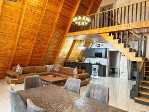 a living room with a couch and a table at Qafqaz Mountain Chalet in Gabala