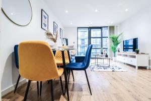a dining room with a table and blue chairs at Canary Wharf-10% discount-Fibre Wifi-5mins to Tube in London
