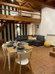 a living room with a table and a couch at Lo Chalet di Ponte Milvio - Auditorium - Foro Italico - Stadio Olimpico in Rome