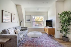 a living room with a couch and a tv at Dupont Circle 1br w wd nr bars metro station WDC-750 in Washington, D.C.