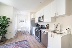 a kitchen with white cabinets and a sink at Dupont Circle 1br w wd nr bars metro station WDC-750 in Washington, D.C.