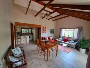 a large living room with a table and chairs at Helderberg Cottage in Somerset West