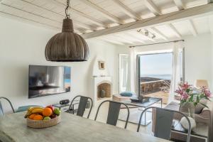 ein Wohnzimmer mit einem Tisch und einer Obstschale in der Unterkunft Villa Crystal by Mykonos Mood in Fanari