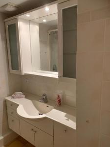 y baño con lavabo blanco y espejo. en Ferienwohnung Waldbaden im Haus Falkenberg, en Oberstdorf