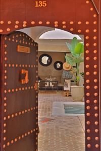 an open door in a room with a living room at Riad Al Badia in Marrakesh